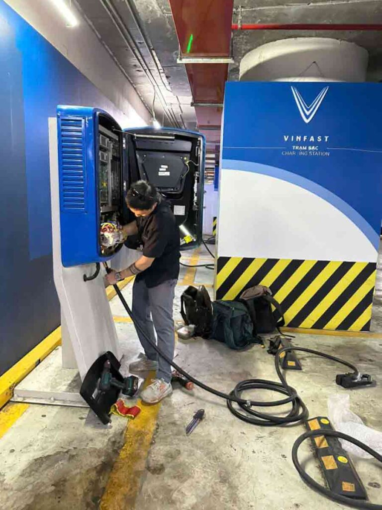 Kỹ thuật viên kiểm tra và sửa chữa trạm sạc ô tô điện VinFast